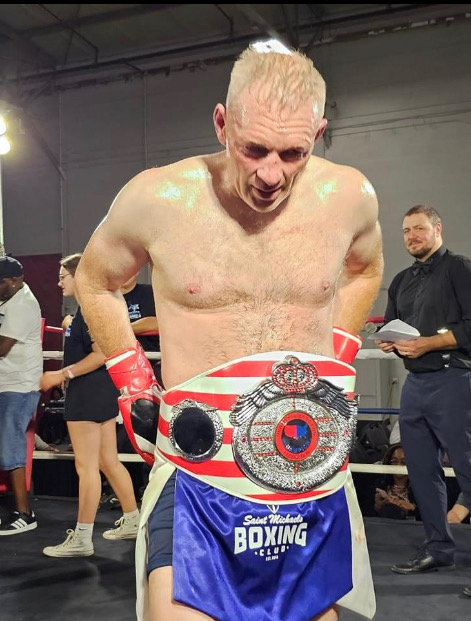 Coach Michael J. Englert with championship belt