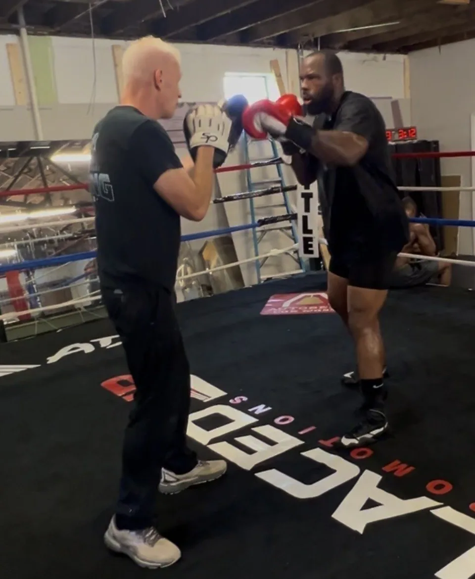 Coach Michael working the mitts with a boxer in the ring