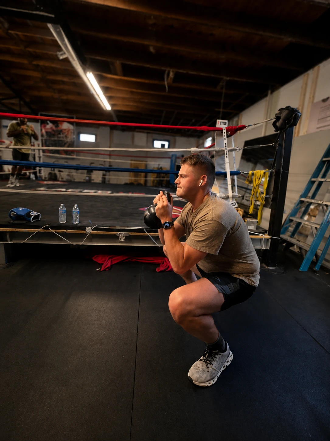 Adult athlete doing kettlebell conditioning beside the ring at Saint Michaels Boxing Club